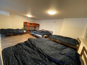 a room with three bunk beds in it at ホテル一休 in Otaru