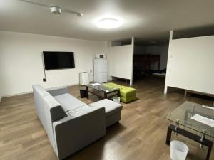 a living room with a couch and a table at ホテル一休 in Otaru