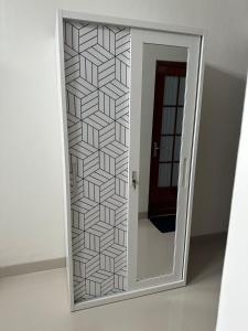 a mirror with a door in a room at Nuwo Adin Syariah Guest House in Tanjungkarang