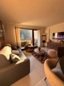 a living room with a couch and a table at SixT Lodge in Saint-Jean-de-Sixt