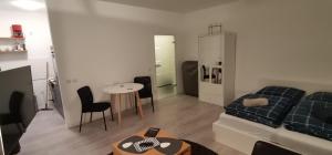 a living room with a couch and a table at Central Apartments Chemnitz KASSBERG in Chemnitz