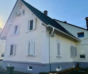 a white house with a black roof at Haus noe in Kehl am Rhein