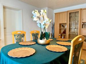 a dining room table with plates and flowers on it at Haus noe in Kehl am Rhein