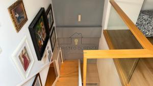 a staircase in a house with pictures on the wall at Calpurnia Casco Viejo in Ourense