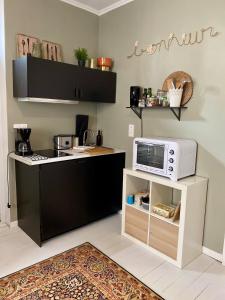a small kitchen with a microwave and a counter at La Parenthèse Champenoise in Épernay