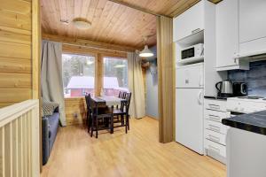 a kitchen and dining room with a table and chairs at Pyhäkoti B - 30 Meters From the Slopes in Pyhätunturi +11 photos