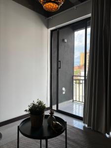 a room with a table and a large glass window at Hotel Moore 45 in Medellín +286 photos