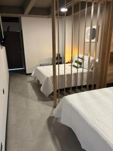 a bedroom with two beds and a mirror at Hotel Moore 45 in Medellín