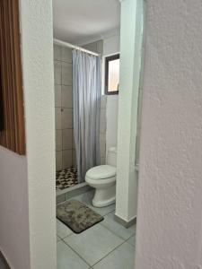 a bathroom with a toilet and a shower at Vegas guest house in Dwarsloop +19 photos