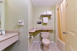 a bathroom with a toilet and a sink at Cheshire Welcome Inn in Cheshire +19 photos