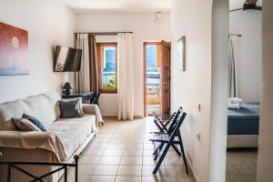a living room with a couch and a bed at Renas Guesthouse in Sitia