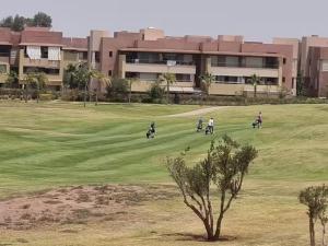 a group of people riding motorcycles on a golf course at appartement prestige golf city in Marrakech