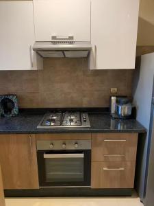a kitchen with a stove and a counter top at appartement prestige golf city in Marrakech +8 photos