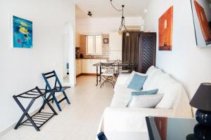 a living room with a white couch and a table at Renas Guesthouse in Sitia