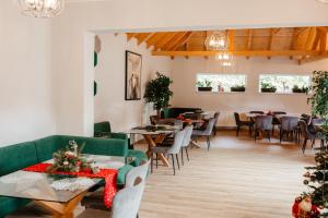 a restaurant with tables and chairs and christmas trees at Pensiunea Draser in Şeica Mică