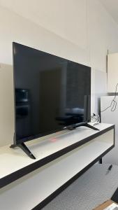 a large flat screen tv sitting on top of a table at Residencial Da Cal in Torres