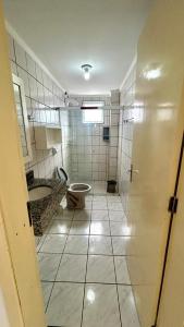 a bathroom with a toilet and a sink and a tub at Residencial Da Cal in Torres +17 photos