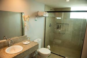 a bathroom with a shower and a toilet and a sink at Hotel Serrano in Campina Grande +136 photos