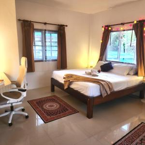 a bedroom with a large bed and a chair at Central Essence-200m beachKoh Phangan west coast in Haad Chao Phao