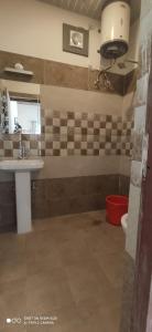 a bathroom with a sink and a toilet at Oak Hill Cottage in Mussoorie