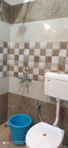 a bathroom with a white toilet and a sink at Oak Hill Cottage in Mussoorie