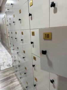 a row of white cabinets with numbers on them at Friends in Osh