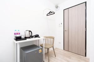 a room with a desk and a table and a chair at Rest Inn Silom Bangkok in Bang Rak