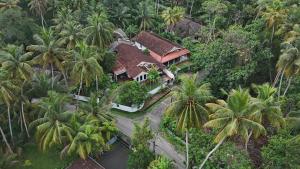 an aerial view of a house with palm trees at Indra Sisila Resort and Villa Bentota in Bentota