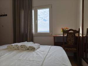 a bedroom with a bed with towels on it at Pansion Danilo by the sea in Krmčina