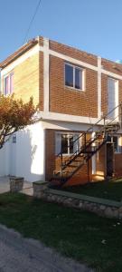 a brick building with a staircase on the side of it at Bella Fefi in Villa Cura Brochero