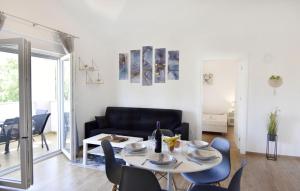 a living room with a table and chairs and a couch at Modern holiday home with shared pool in Čepljani