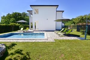 a house with a swimming pool in a yard at Modern holiday home with shared pool in Čepljani