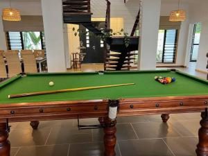 a pool table with cue balls and balls on it at BIG Beach House Tranquility in Kewarra Beach