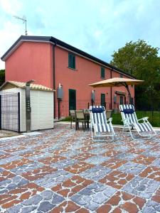 a group of chairs sitting on a stone patio at -La Bella Ameglia- Private Parking in Luni