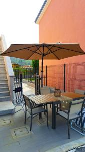 a table and chairs under an umbrella on a patio at -La Bella Ameglia- Private Parking in Luni +4 photos