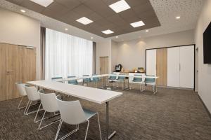 a conference room with a long table and chairs at Hilton Garden Inn Bordeaux Centre in Bordeaux