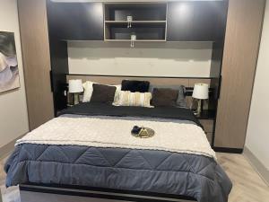 a bedroom with a large bed with two lamps at Modern 7 Bedroom Masterpiece on Portage Sleeps 16 in Niagara Falls