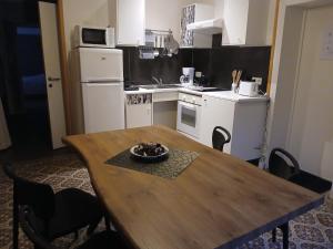 a kitchen with a wooden table with a bowl on it at li ptit coeur in Hastière-Lavaux