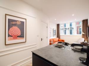 a kitchen with a table with wine glasses on it at Calico at The Heim Residences in Manchester