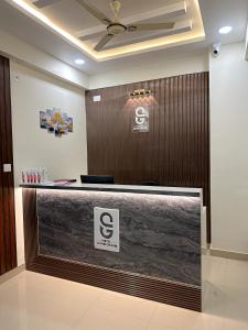 a lobby with a reception desk in a building at Hotel SAFKO Grand - Hopefarm Metro Whitefield in Bangalore
