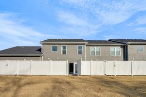 een huis met een wit hek voor een huis bij WFH Setup, Fenced Yard! Spacious Spring Hill Stay in Kedron