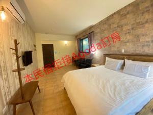 a hotel room with a bed and a television at Starry Night in Taitung City