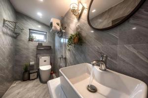 a bathroom with a sink and a mirror at Le'Mon in Da Lat +44 photos