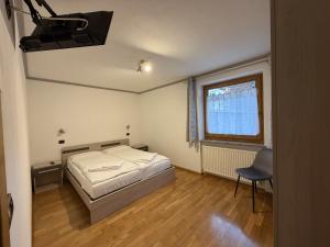 Un pat sau paturi într-o cameră la Appartamento Star Begn - Piano Terra