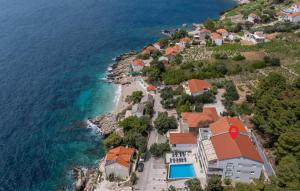 an aerial view of a house on a hill next to the ocean at Cozy Apartment In Potomje With Lake View in Potomje +21 photos