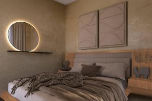 een slaapkamer met een bed en een spiegel aan de muur bij Villa Kalymnos by Villa Plus in Kolimbia +9 foto's