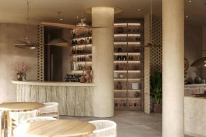 een restaurant met tafels en stoelen en een wijnkelder bij Villa Kalymnos by Villa Plus in Kolimbia