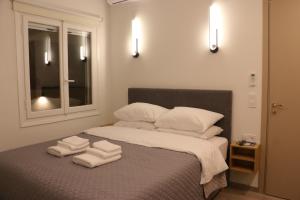 a bedroom with a bed with towels on it at FaliroRelax F2 in Athens