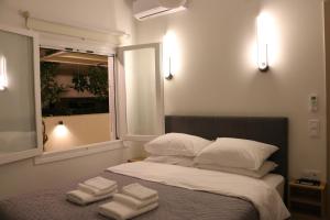 a bedroom with a bed with towels on it at FaliroRelax F2 in Athens