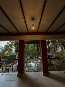 an empty house with a large glass door and a light at Rockviewstay in Kalpetta